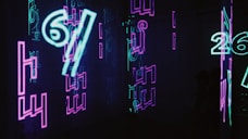neon signs are lit up in a dark room