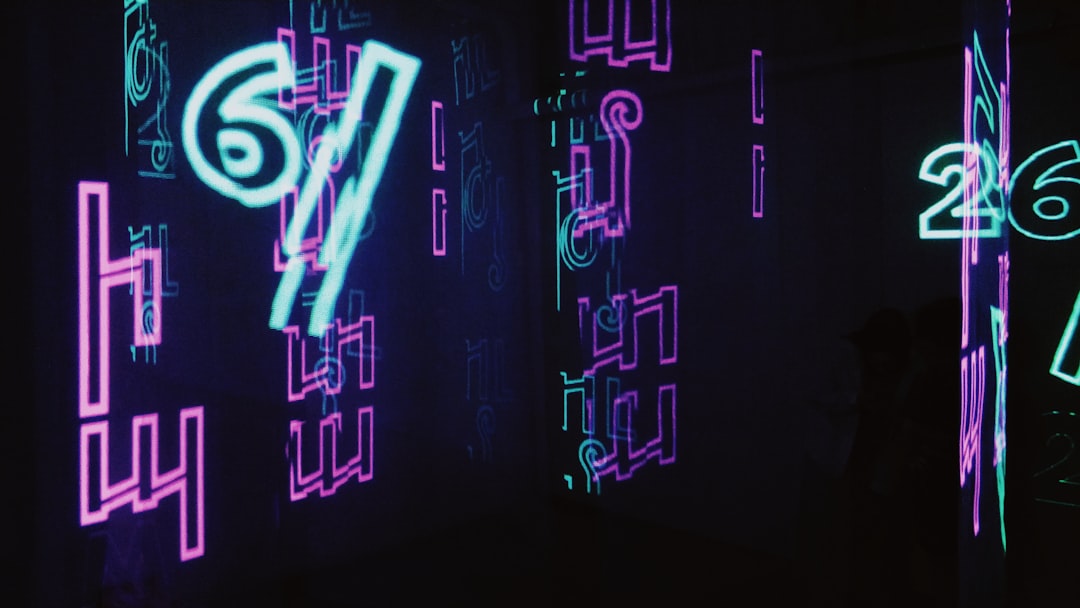 neon signs are lit up in a dark room,