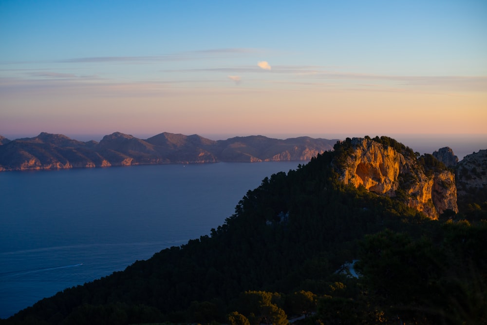 aerial photography of green mountains and blue sea during daytime