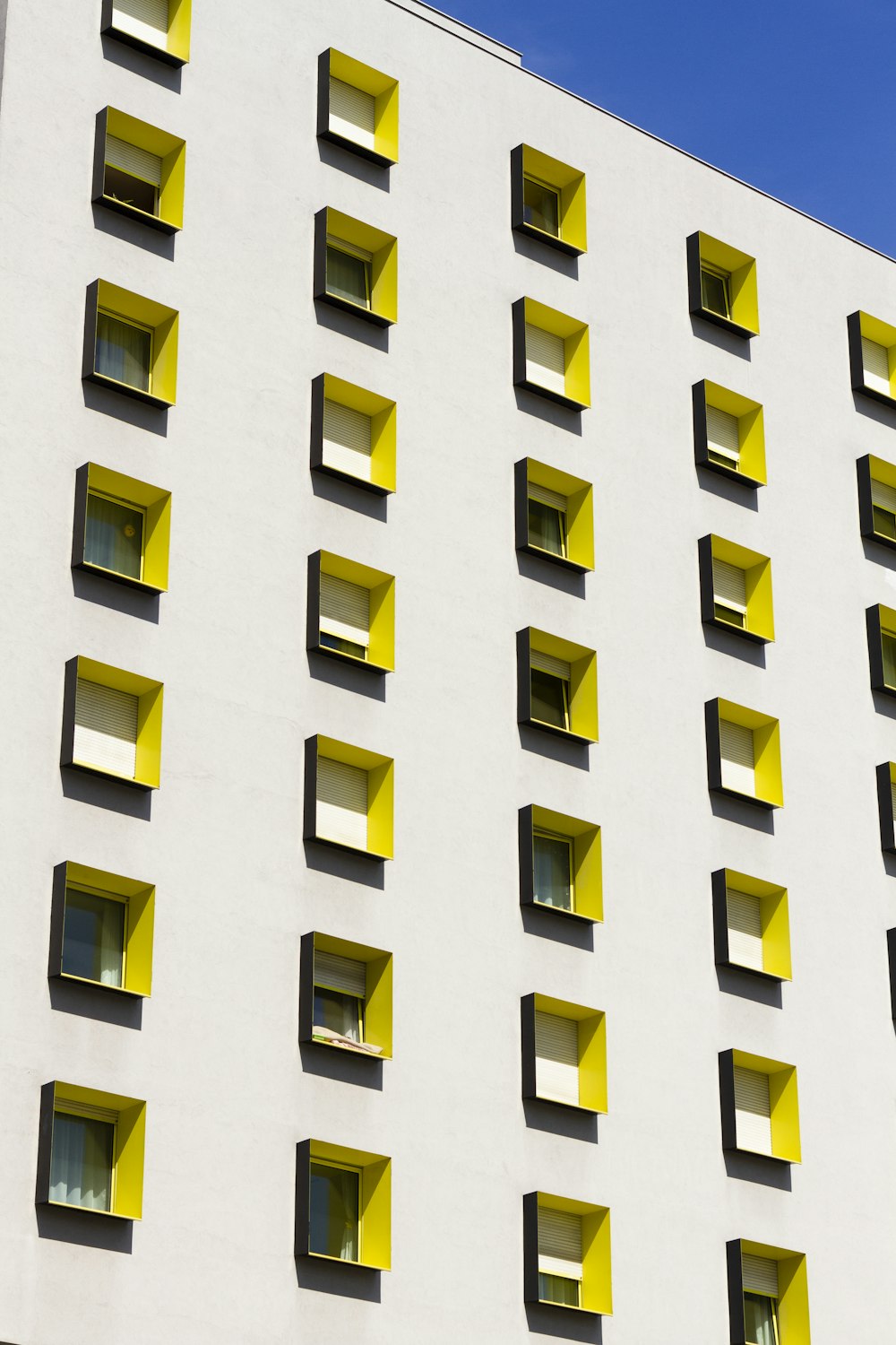 white building with yellow windows during day