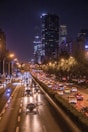 cars passing by buildings during nighttime