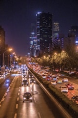 cars passing by buildings during nighttime