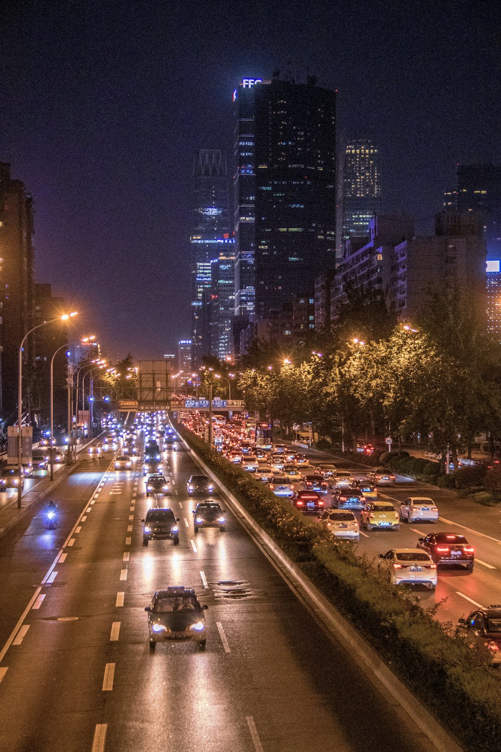 cars passing by buildings during nighttime