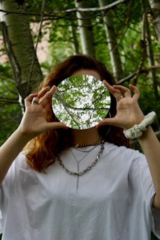 woman in white top near trees