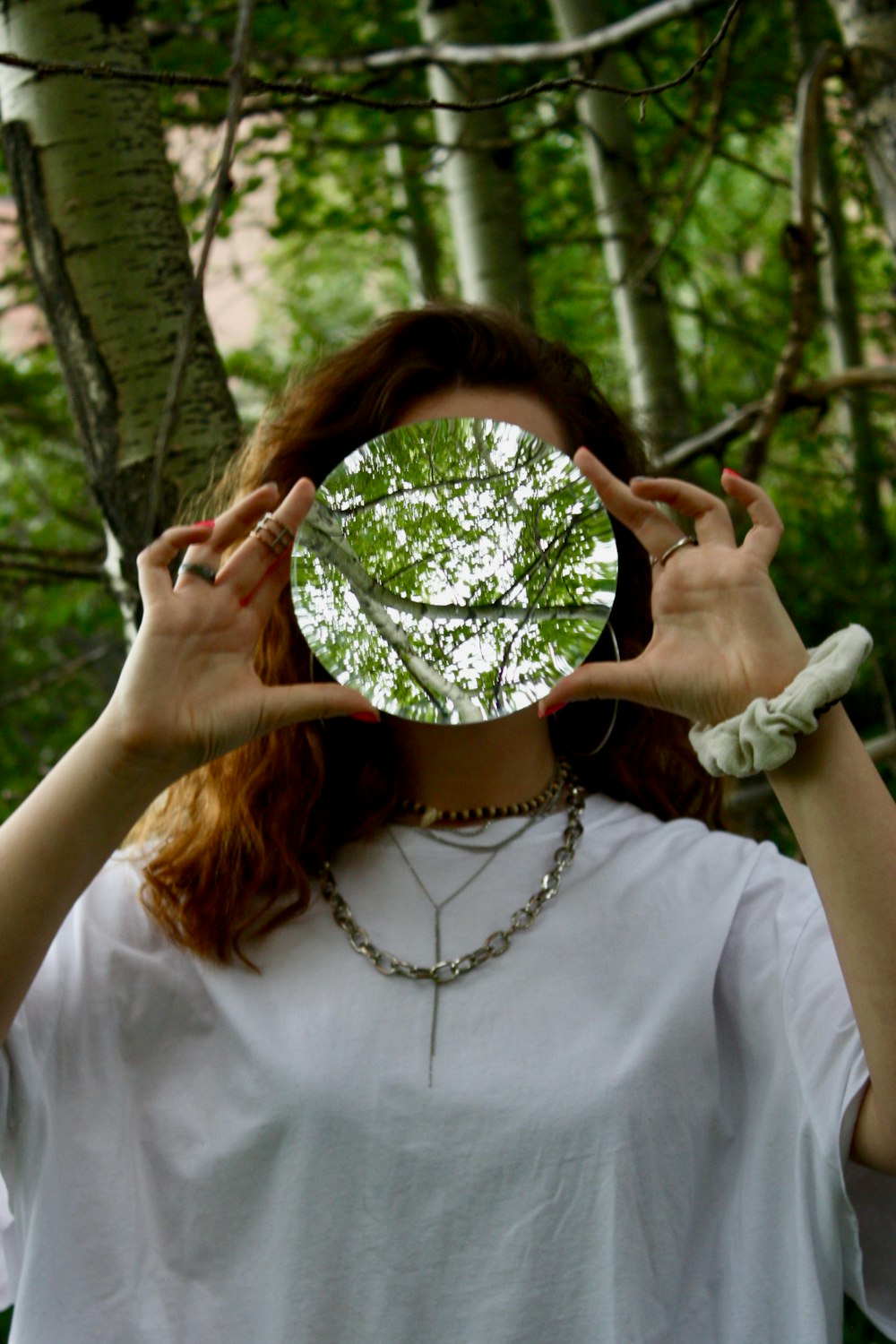 woman in white top near trees