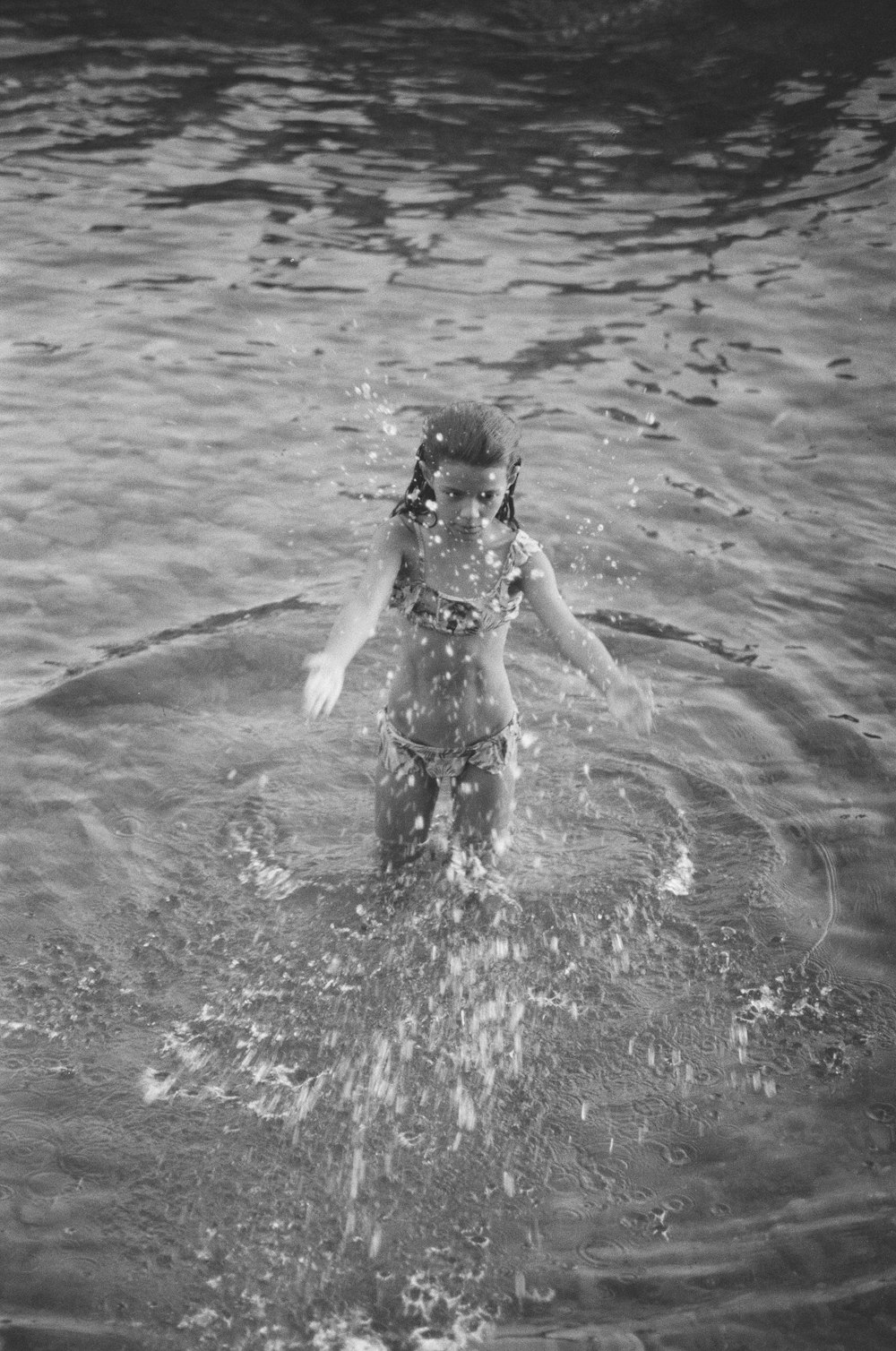 grayscale photo of woman on water