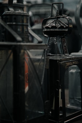A collection of vintage lamps displayed on a rustic wooden table with soft lighting.