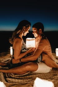 man sitting beside woman