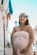 pregnant woman smiling near building during day