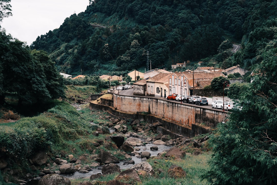 houses on rock mountains, A small town on the island of Sao Miguel. This small town is the first thing you see when you 