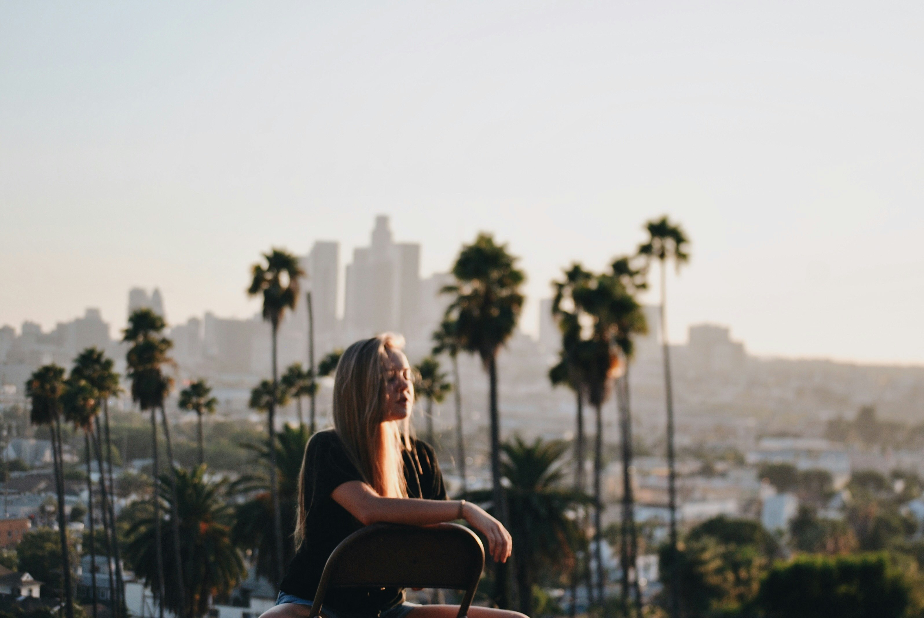 woman sits with city background