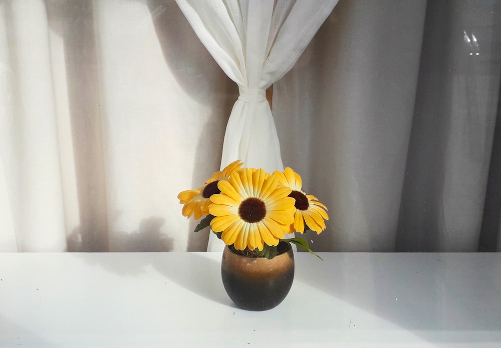 yellow flowers in brown flower vase