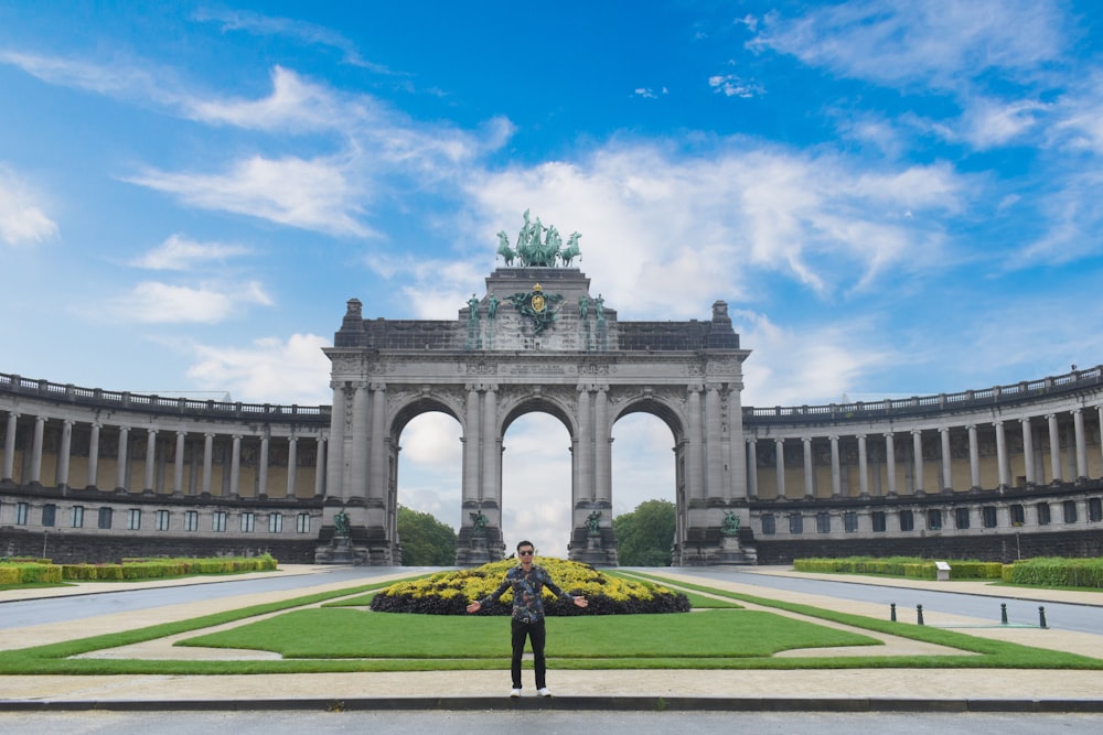 a man standing in front of a large building