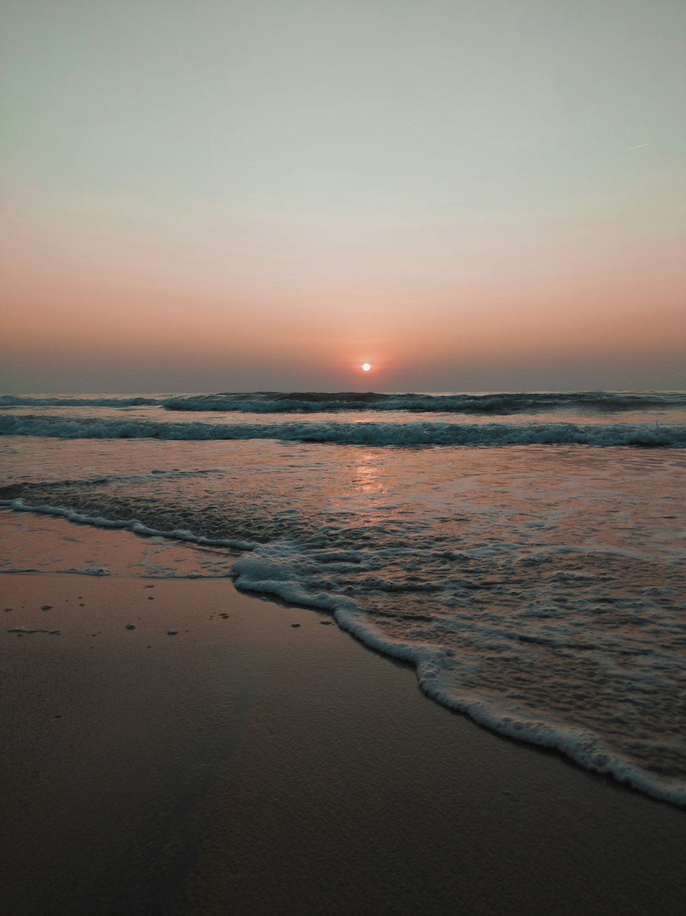 waves splashing on seashore during golden hour