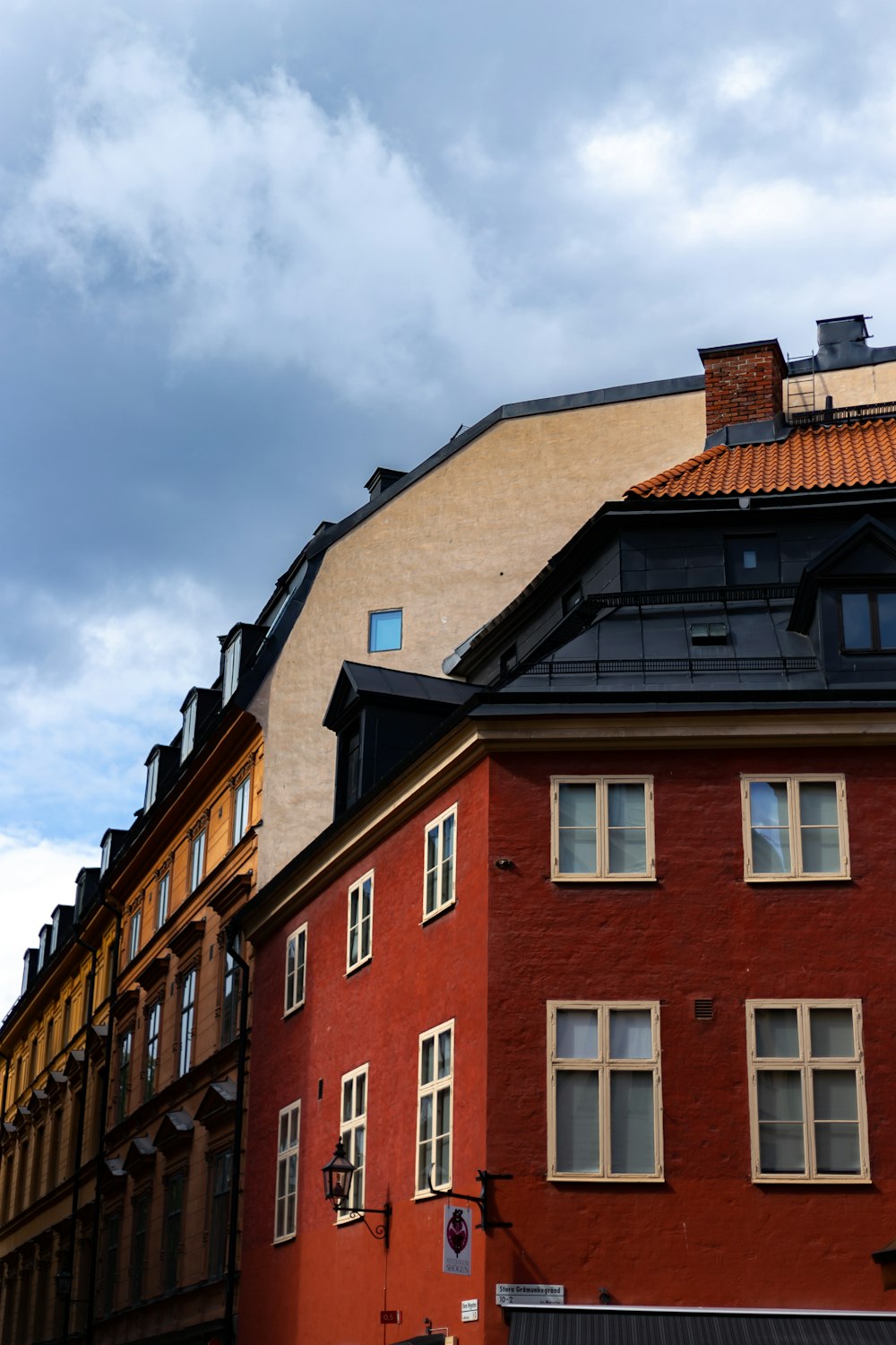 red and brown concrete multi-storey building under a cloudy sky