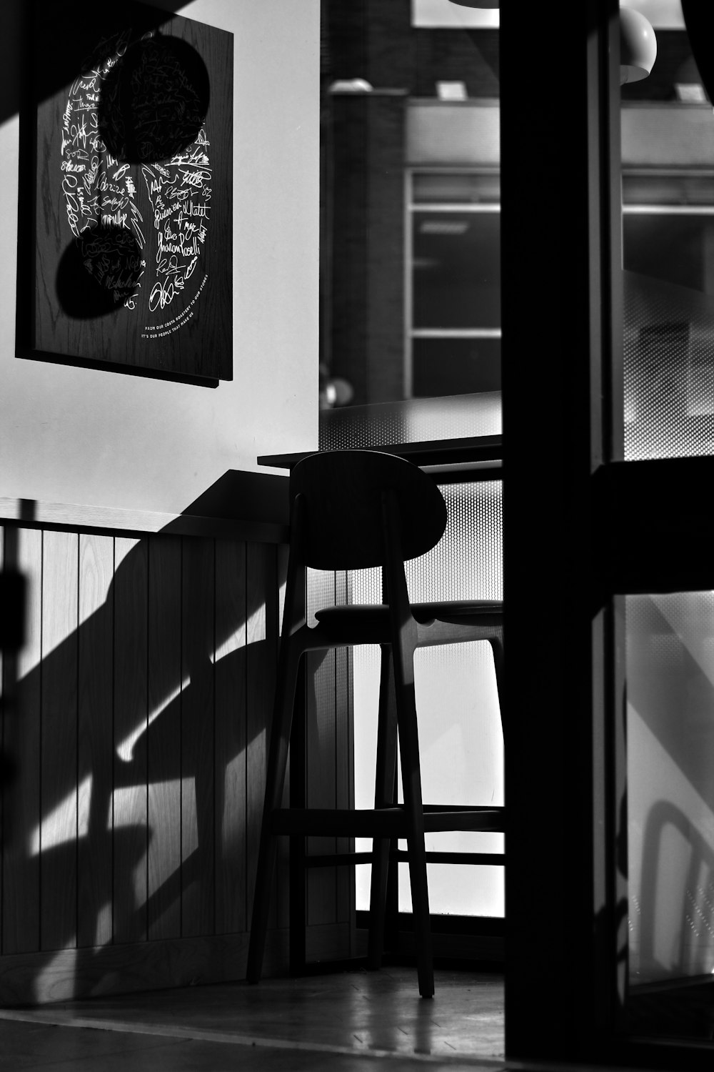 a black and white photo of a bar stool