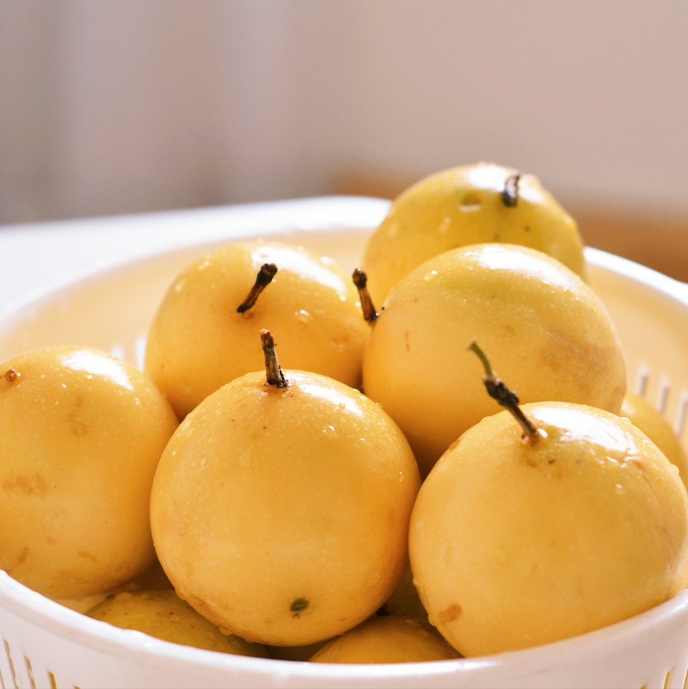 round yellow fruits in bowl