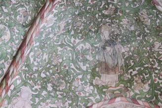 An intricate mural featuring traditional Latin American textiles intertwined with Islamic calligraphy and Caribbean flora.