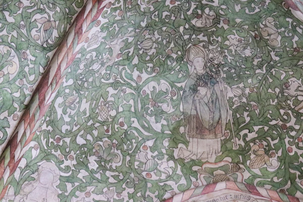 A vibrant religious artwork featuring traditional Puebla motifs.