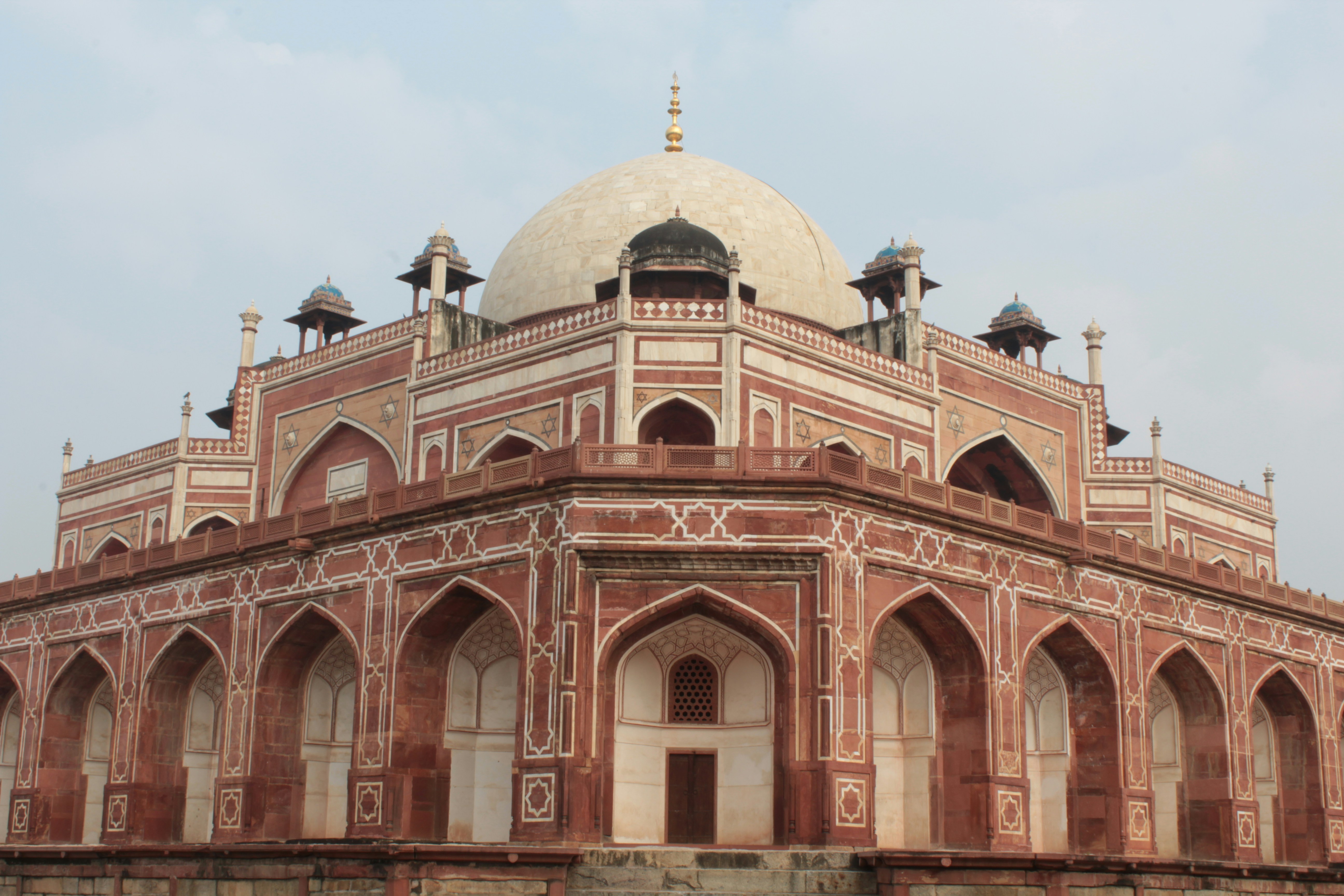 low-angle photography of red concrete dome top mosque