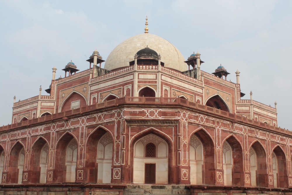 low-angle photography of red concrete dome top mosque