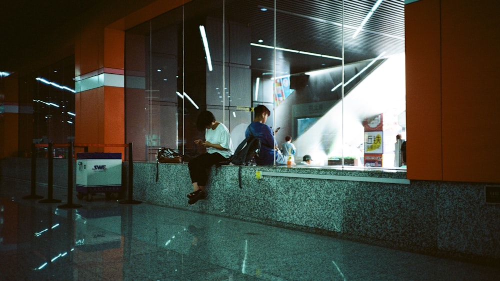 man sitting on concrete surface