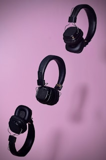 An artistic arrangement of different headphone models on a stylish background.
