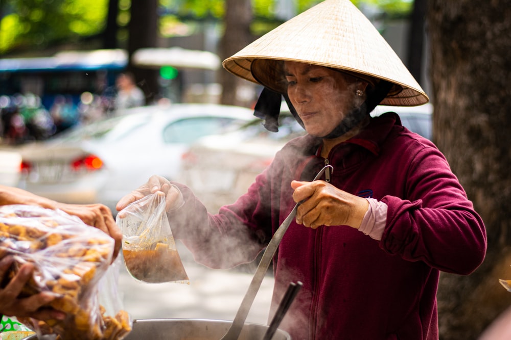 woman pouring food on plastic pack