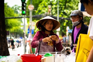 A traveler savoring exotic street food while chatting with a friendly vendor