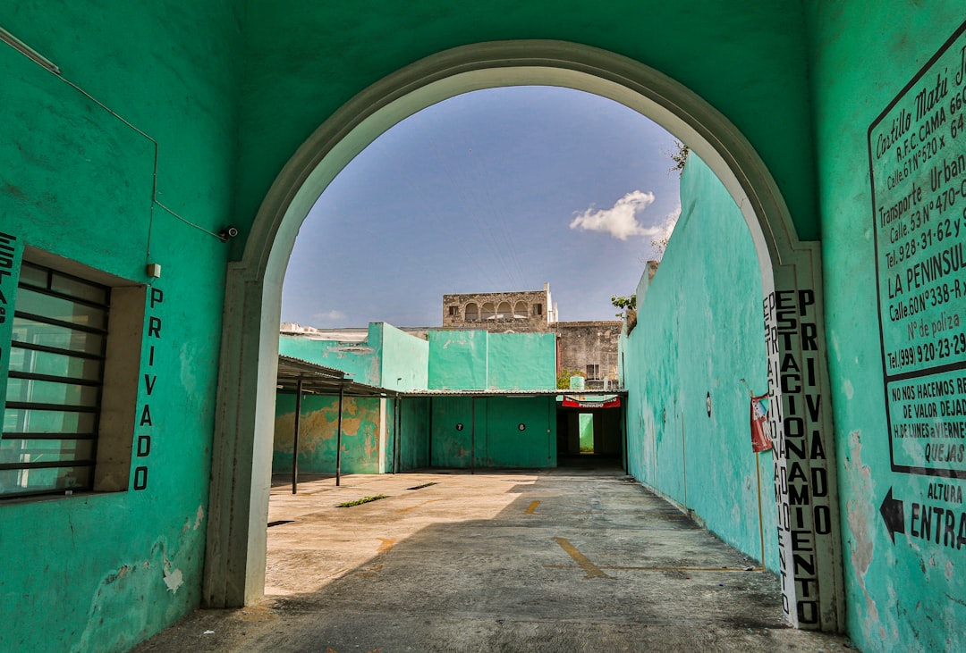 empty green and gray concrete hallway during daytime