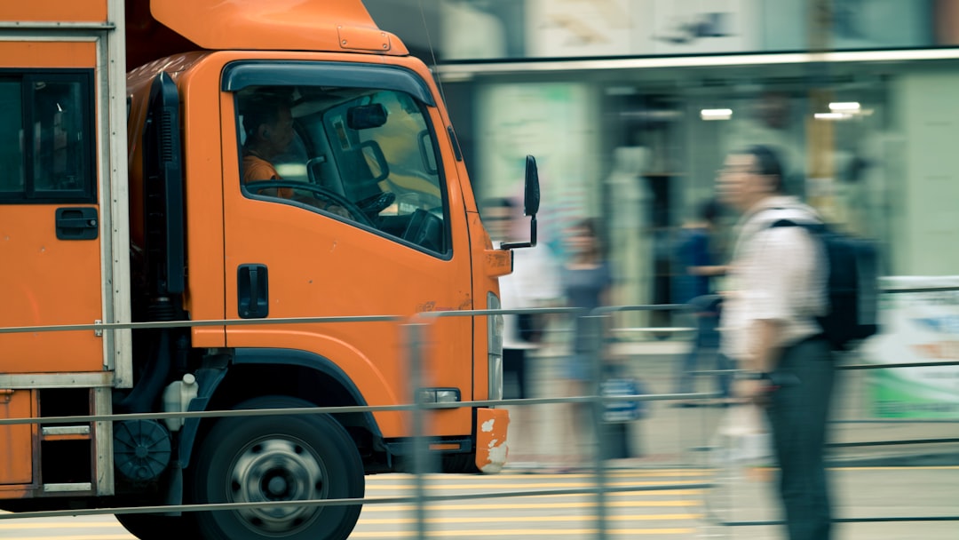 person standing near orange truck