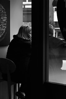 A candid photo of a model reviewing economic notes in a cozy café setting.