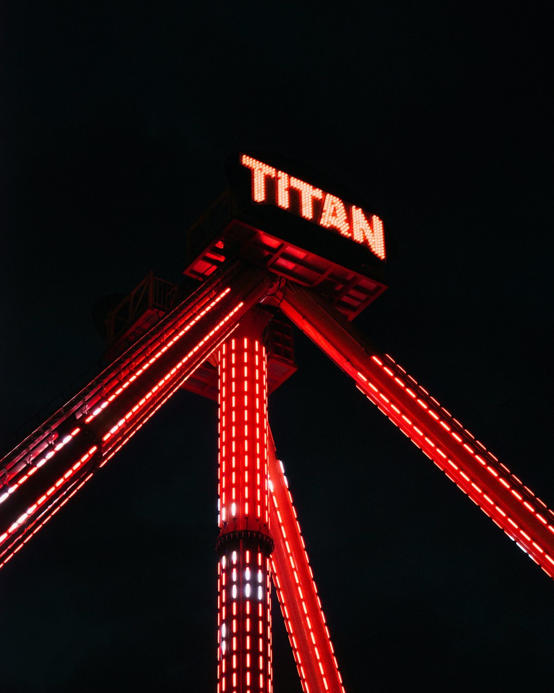 view of Titan amusement ride at nighttime