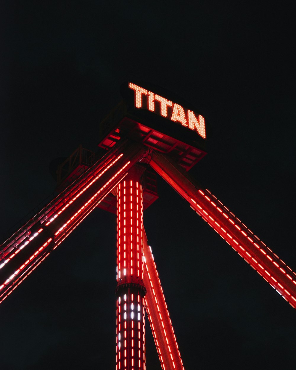 view of Titan amusement ride at nighttime