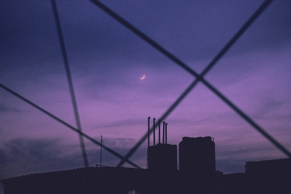 a view of a city skyline through a fence