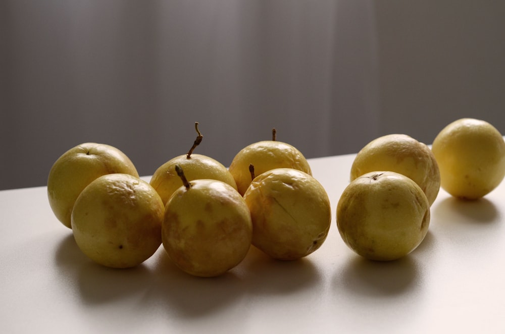 yellow fruits on white table