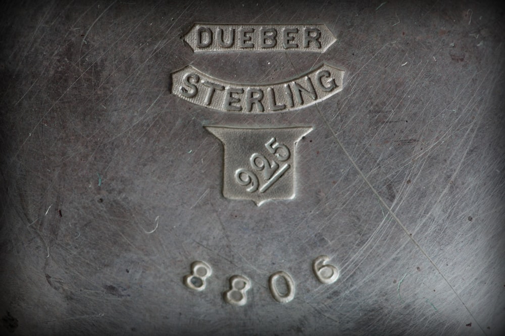 a close up of a metal object with writing on it
