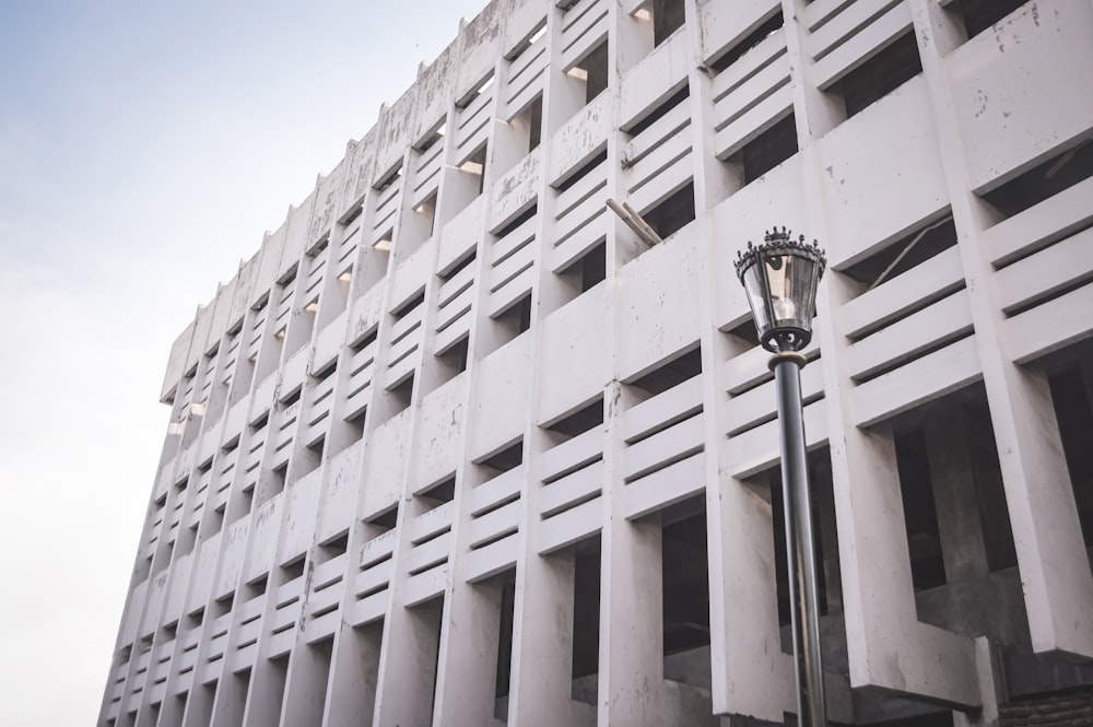 a street light in front of a white building