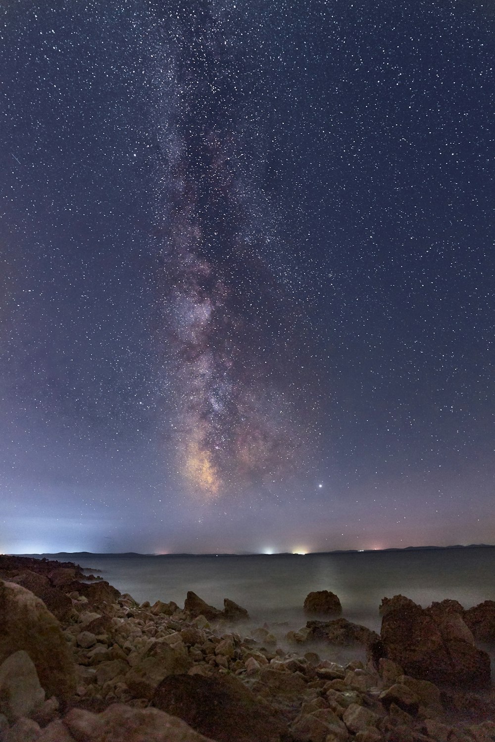 rocks near body of water at night