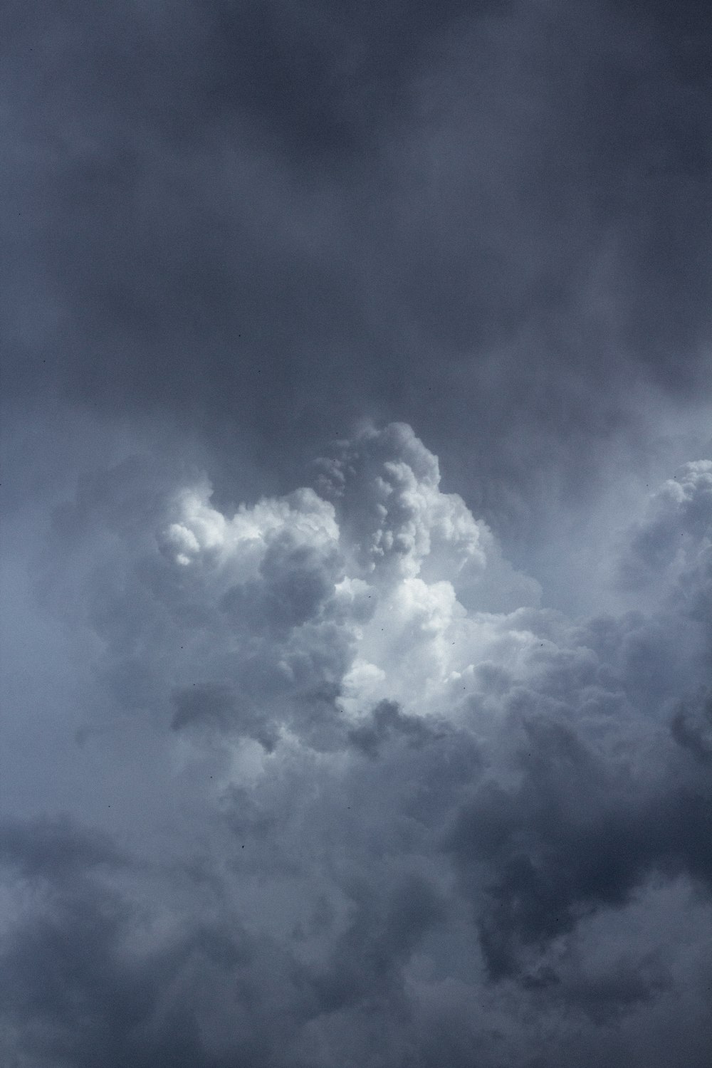 a plane flying through a dark cloudy sky