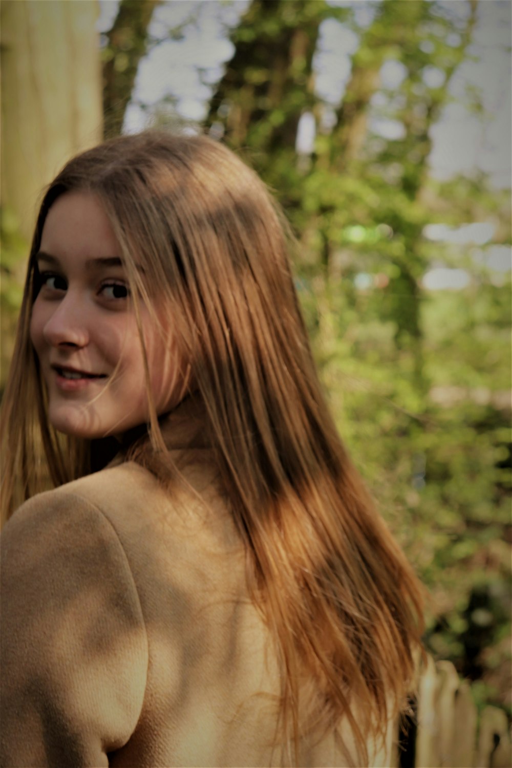 woman wearing brown coat macro photography