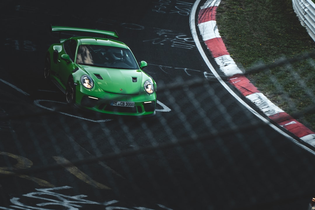 green coupe on race track