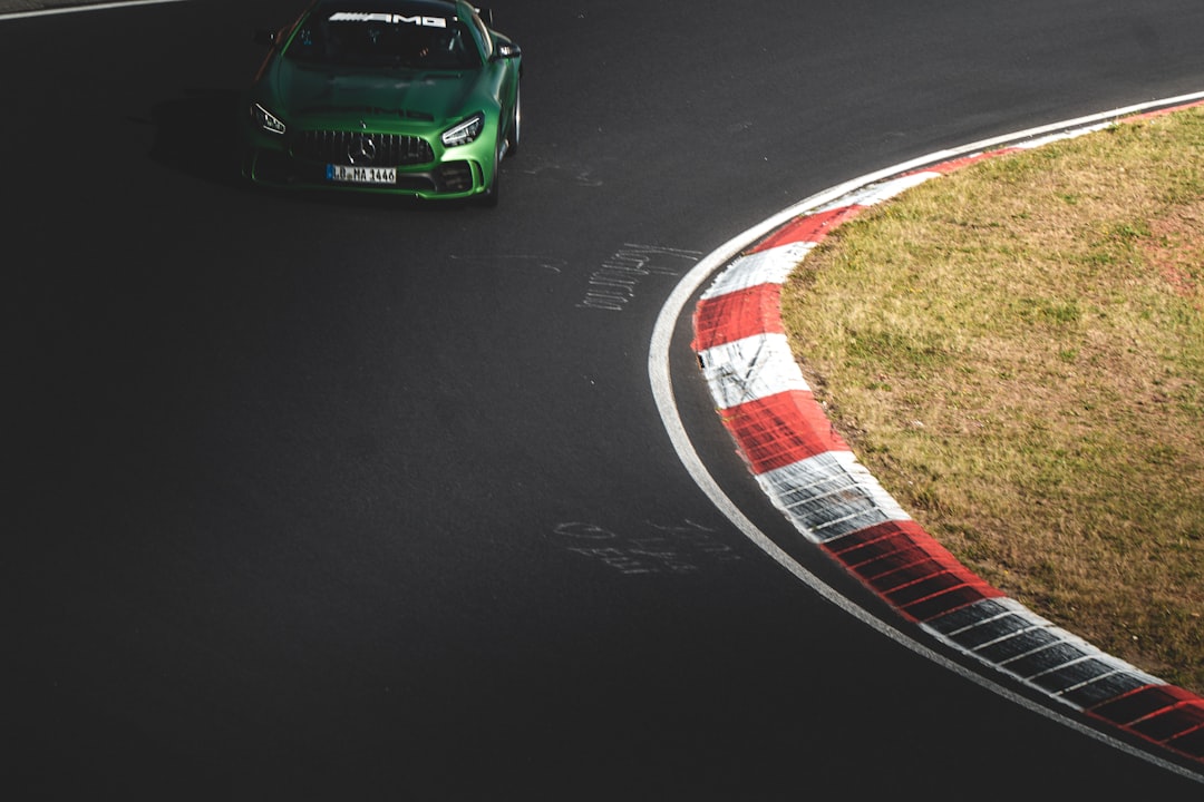 green coupe on race track