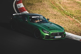 A Mercedes-AMG GT captured in motion, hugging a sharp curve on the Nürburgring track.