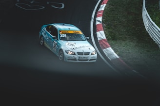 Dynamic shot of a Formula 1 car speeding on a circuit with blue branding.