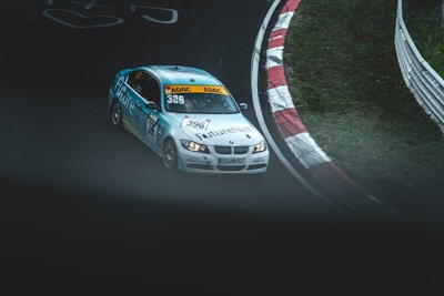 Dynamic shot of a Formula 1 car speeding on a circuit with blue branding.