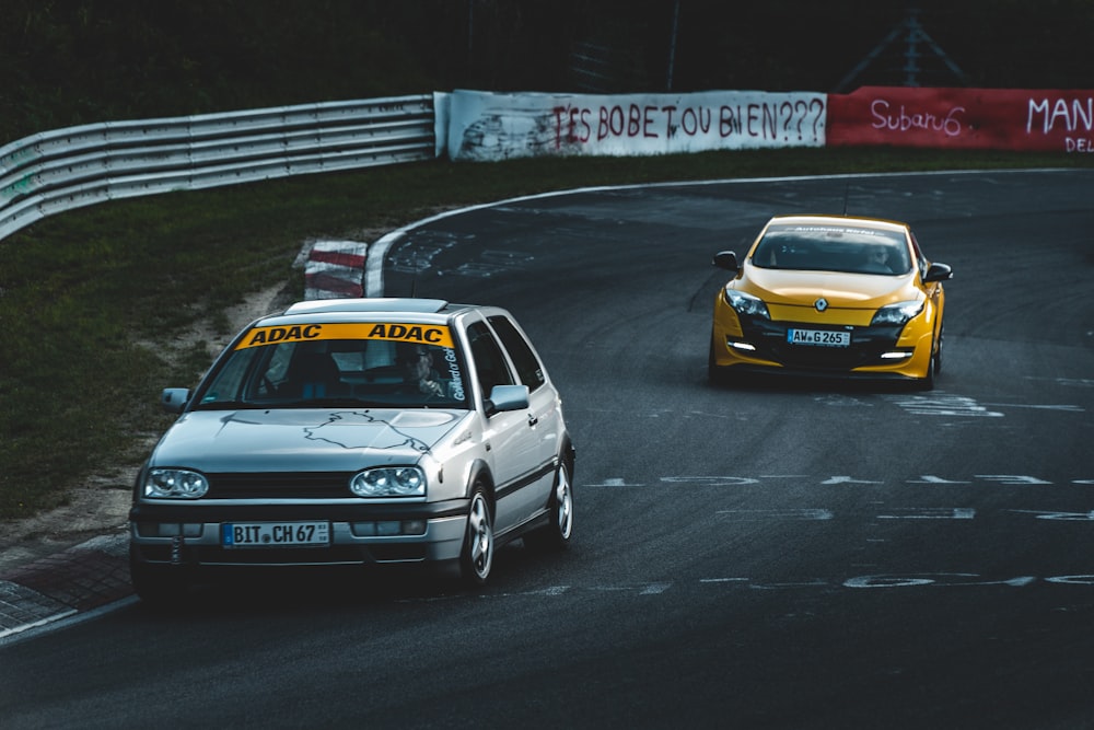 coche blanco corriendo delante de otro coche amarillo