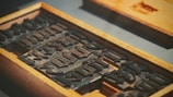 metal stamp set inside wooden case
