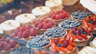 A vibrant display of seasonal fruit tarts ready to be enjoyed.