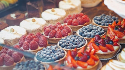 A vibrant display of assorted fruit tarts.